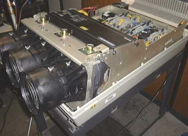 Barco Data 800 with top cover open showing internal CRT tubes, black lens barrels, liquid cooling plumbing, and main electronics chassis on stand — side/top view
