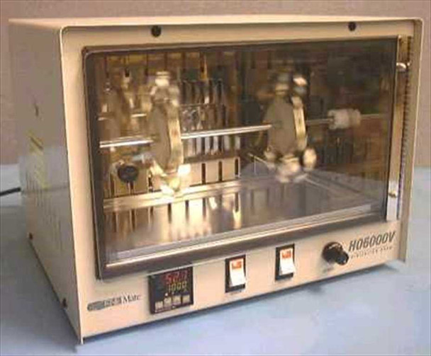Gene Mate HO6000V Hybridization Oven – front three-quarter view showing clear door, rotating bottle rack with stainless tube holders, interior lamp, and front-panel digital controller with two rocker switches and rotary knob