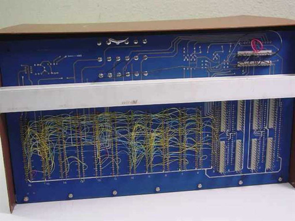 CMC Alarm-Matic System 4000 wire wrap circuit board close-up showing dense yellow and green hand-wired connections on blue PCB