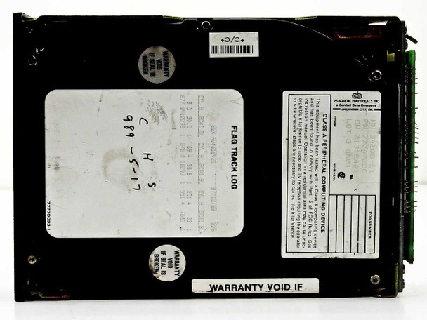 CDC 94205-51 MFM hard drive — bottom/rear view showing Magnetic Peripherals Inc. rating label, flag track log label with handwritten notes, warranty void sticker, and barcode