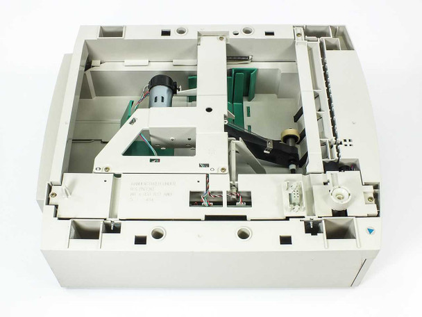 Lexmark 11K0575 Optra T paper tray – top-down interior view showing paper feed motor, lift plate, guide rails, wiring harness, and internal components