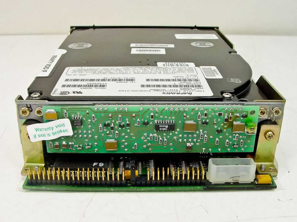 Imprimis 94208-75 half-height IDE hard drive — rear view showing 40-pin IDE connector, 4-pin Molex power connector, green PCB with ICs, and warranty void seal