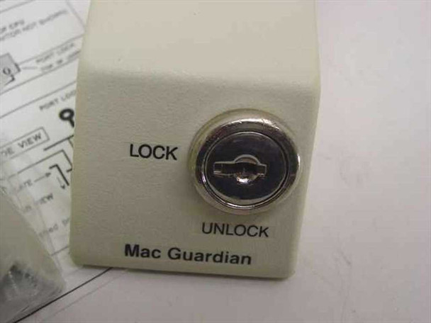 MAC Guardian port lock unit close-up — keyed lock cylinder with LOCK and UNLOCK labels on beige housing