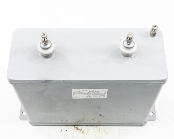 TOEI O82130 capacitor – top-down view showing two main terminals, label, and gray steel enclosure top surface