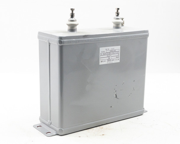 TOEI O82130 capacitor – three-quarter right rear view showing gray enclosure, two ceramic terminals, and base flanges