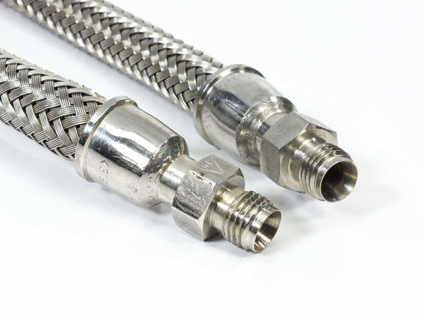 Side-by-side comparison of both Swagelok FM Series hose ends showing stainless crimped fittings and male NPT threads at varying focus depths