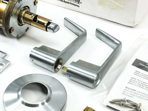 Schlage AL53PD SAT 626 lever handles pair and rose plate in satin chrome finish, with chassis and strike plate visible