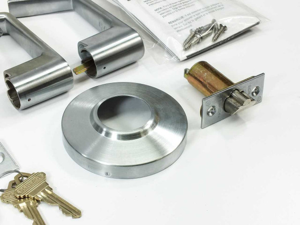 Schlage AL53PD SAT 626 components laid out: pair of Saturn lever handles, rose plate, latch assembly, keys, screws bag, and strike plate
