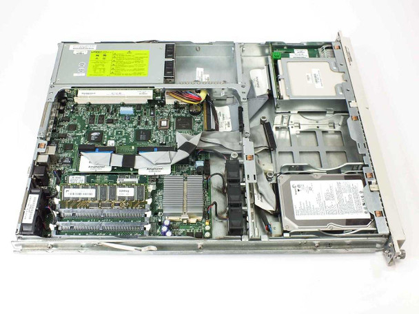 Compaq ProLiant DL320 interior view with lid removed showing motherboard, RAM modules, CPU with heatsink, hard drive, power supply, and floppy drive