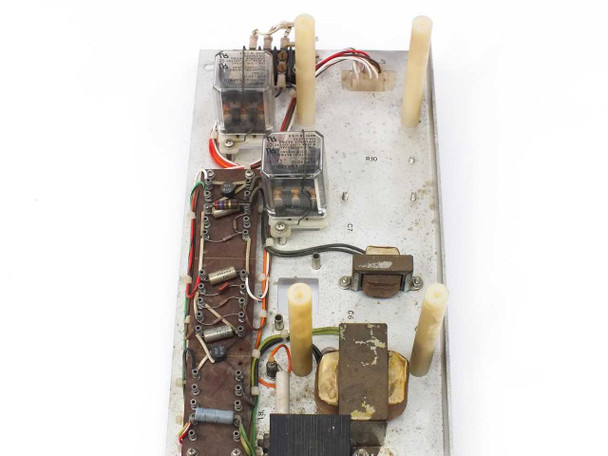 Close-up top-down view of PCB showing two AMF Potter and Brumfield relays, small transformer, capacitors, and wiring harness