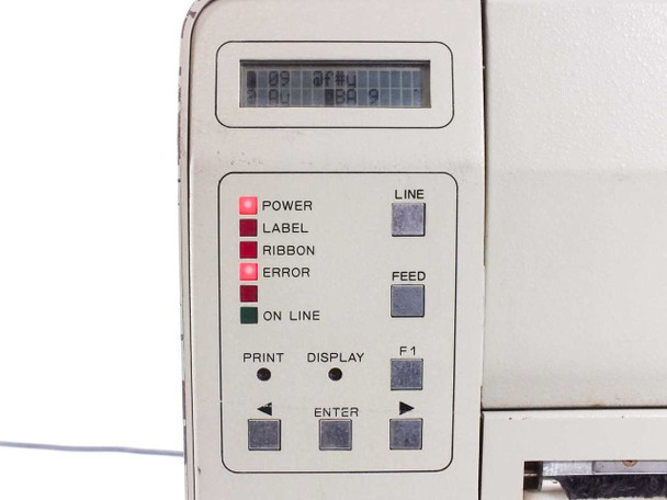 SATO M-8400 close-up of front control panel showing LCD display with garbled text, POWER/LABEL/RIBBON/ERROR/ON LINE LED indicators, and LINE, FEED, F1, PRINT, DISPLAY, ENTER buttons