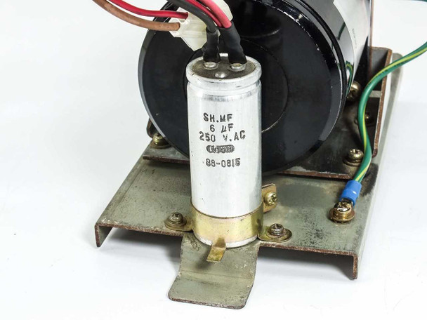 Close-up of SH.MF 6uF 250VAC run capacitor mounted to metal base plate bracket with motor wiring visible above