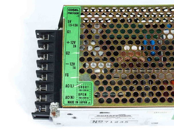Cosel PMC100E-1 power supply – close-up of terminal block label showing 5V, +12V, -12V outputs and AC input wiring diagram