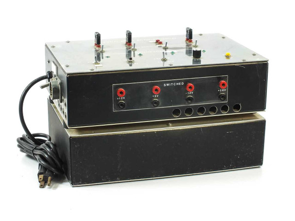 Rockwell Display Module Supply Controller front panel showing SWITCHED banana-jack outputs labeled +12V, +5V, -12V, +28V with red and black binding posts, stacked two-unit assembly with AC cord