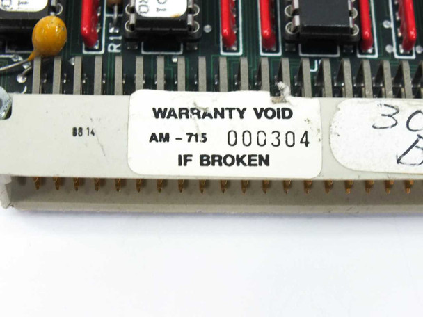 Alpha Micro AM-715 memory board close-up of edge-connector label showing model AM-715, serial number 000304, and WARRANTY VOID IF BROKEN sticker
