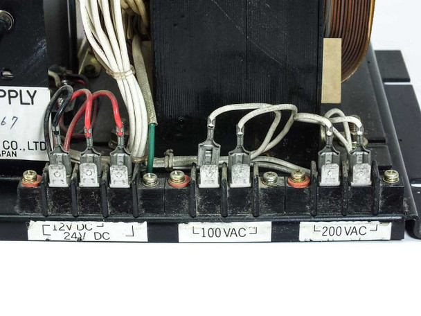 Kitafuji Origin 0038 terminal block close-up showing 12V DC, 24V DC output terminals and 100VAC, 200VAC input terminals with wiring