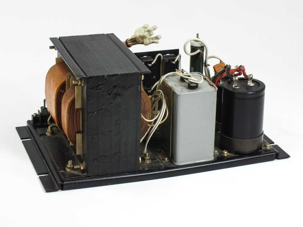 Kitafuji Origin 0038 power supply – rear three-quarter view showing transformer core copper windings, filter capacitor, and small gray component