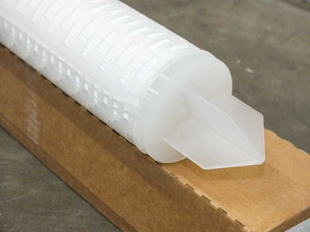 Close-up of FCWN540S2780 filter cartridge opposite spear end showing translucent polypropylene end cap detail