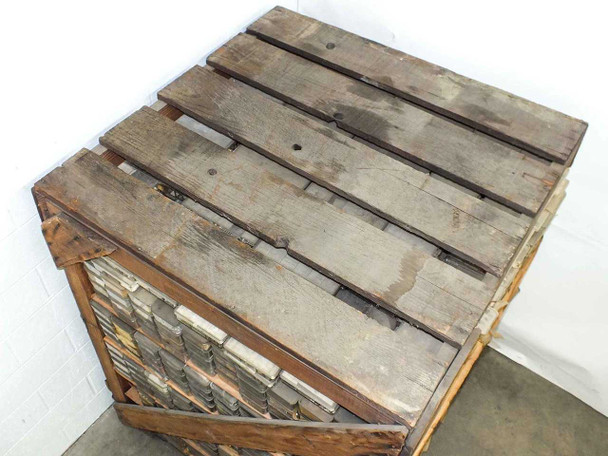 Top-down view of the wooden crate lid showing weathered planks and the tops of parts bins visible at edges