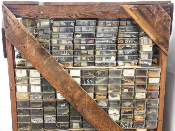 Full side view of crate showing dense packing of parts bins from floor to ceiling