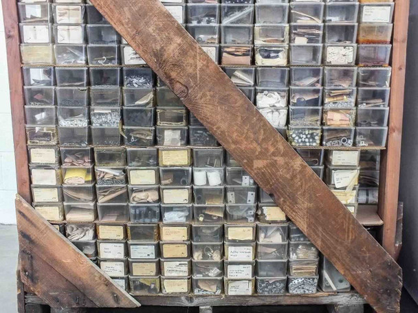 Bottom pallet section showing multiple rows of bins with assorted small parts visible through clear drawer fronts