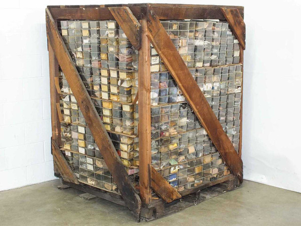Large wood-and-wire pallet crate packed floor-to-ceiling with hundreds of small labeled parts bins — full crate front view