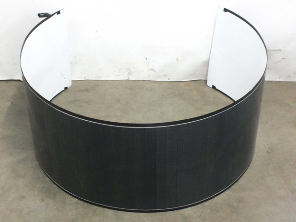 Solopower SP1 flexible CIGS solar panel rolled into a cylinder shape showing dark photovoltaic cell surface and white ETFE backing with MC4 connector leads