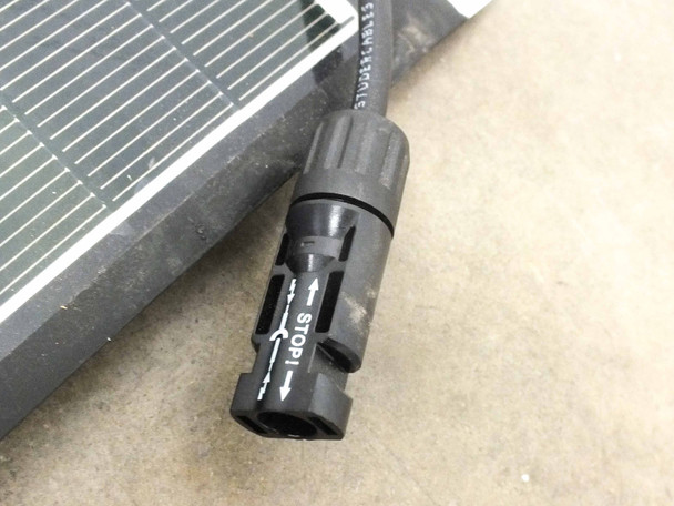 Close-up of MC4 female connector on Solopower SP1 solar panel cable showing socket end with STOP locking mechanism