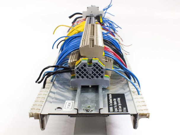 Side profile view of complete DIN rail assembly showing wiring depth and label strip on aluminum rail