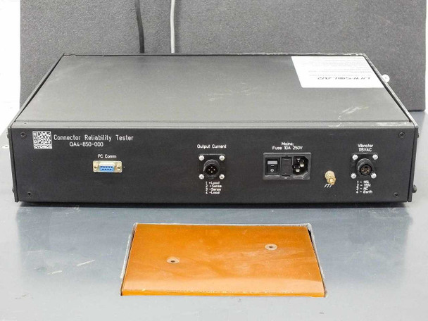 ECD Ovonics QA4-850-000 rear panel — PC Comm DB-9 port, Output Current connector, Mains Fuse 0A 250V IEC inlet, Vibrator 110VAC terminal, orange test pad visible below