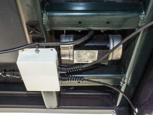 Underside of QA4-850-000 test station — Netter Vibration NEA-5050 vibrator motor mounted beneath tabletop with cabling and junction box