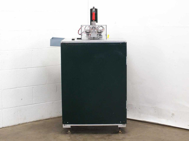 Custom blind rivet station rear-left corner view showing green enclosed cabinet body, aluminum extrusion frame base, and pneumatic upper assembly on top