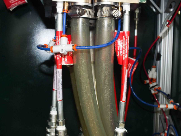 High-pressure Spir Star DPS221-384 hose bundle detail — two stainless-braided hoses with hose clamps, blue and red tubing, and Spir Star warning tags