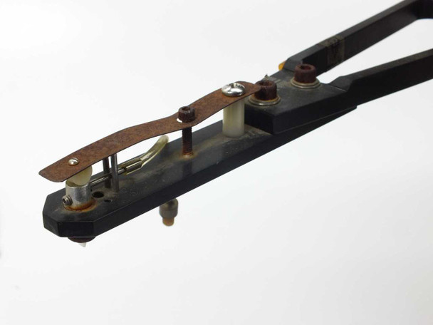 Laurier HA245 die loader – close-up of pick arm end effector / die pickup head showing surface rust and mechanical linkage detail