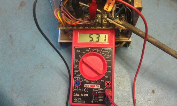 Semtrol PS105-21 being tested with Cen-Tech digital multimeter reading 5.31 VDC on the +5V output terminal