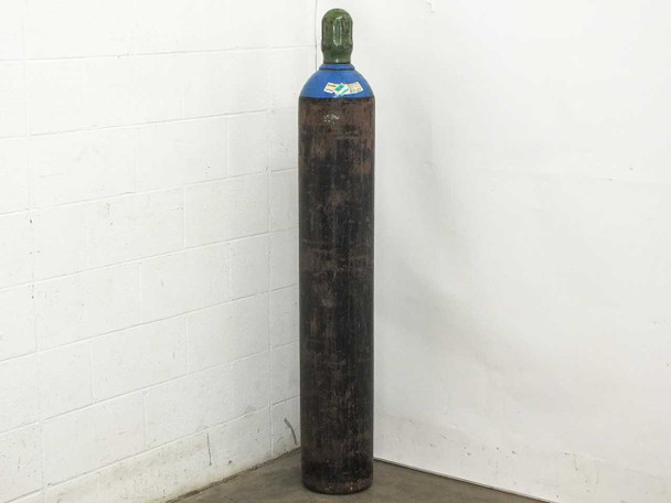 Linde US Welding nitrogen gas tank full view showing blue cylinder body with green cap and heavy exterior wear