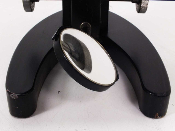 Alternate view of horseshoe base and substage mirror; paint loss on base feet clearly visible