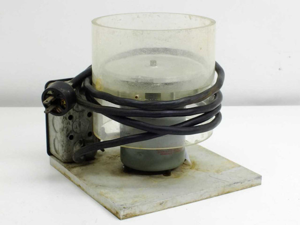 Unbranded spin coater spinner rear/side view showing motor housing, power cord, and clear cylindrical bowl on base plate