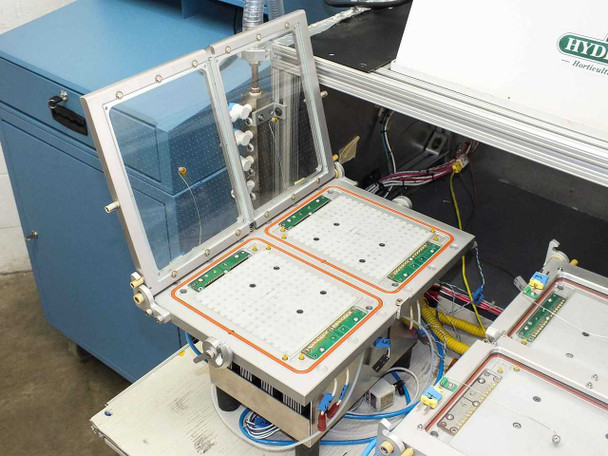 Hydrofarm PS-24-20 Solar Soak System — open lid on TE module tray showing dual cell fixture plates with orange gasket seals and circuit boards visible beneath acrylic/glass lid