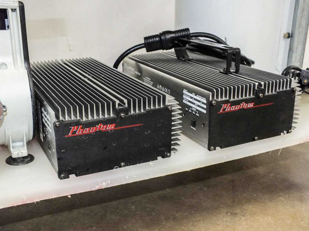 Two Phantom PHE1THD dimmable digital ballasts on lower shelf — black anodized aluminum finned housings with Phantom and Hydrofarm branding, power cords connected