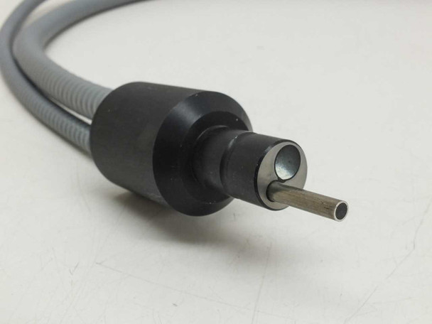 Close-up of input light tip — cylindrical black ferrule with central fiber optic pin protruding