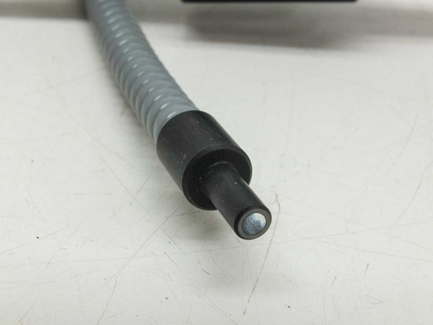 Close-up of extra tip cable end — smaller black ferrule with single fiber optic tip