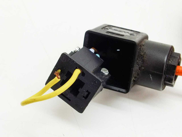 Damaged black solenoid connector end with exposed yellow wires and orange cable