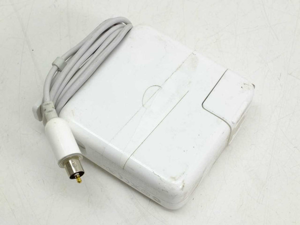 Apple A1021 65W AC power adapter bottom/side view showing scuff wear on white casing and fold-out prong slot
