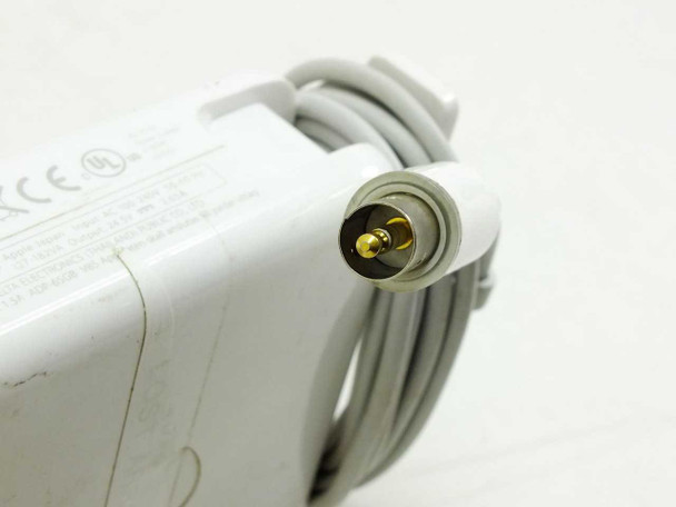 Close-up of Apple A1021 barrel connector tip showing gold-pin circular DIN-style DC output plug
