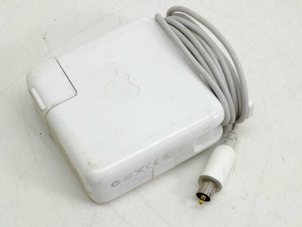 Apple A1021 65W AC power adapter top view showing Apple logo, gray barrel connector cable, and CE/UL certification marks
