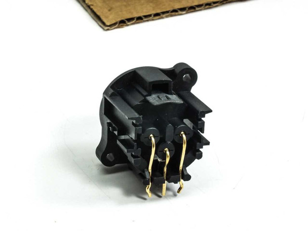 Neutrik NC3MAH male XLR receptacle close-up – rear/solder-side view showing three gold-plated through-hole pins and black UL94V-0 plastic housing detail
