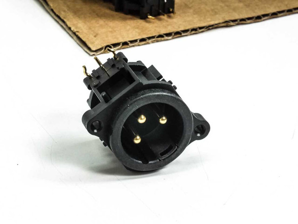 Neutrik NC3MAH male XLR receptacle close-up – front/mating-face view showing three gold-plated male pins inside circular XLR opening and PCB mounting tabs