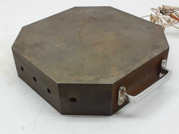 Steel heating element block – side profile showing fold-down aluminum handle and vent holes on edge
