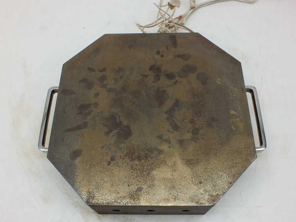 Steel heating element block – top surface view showing oxidation and surface patina across the full octagonal platen